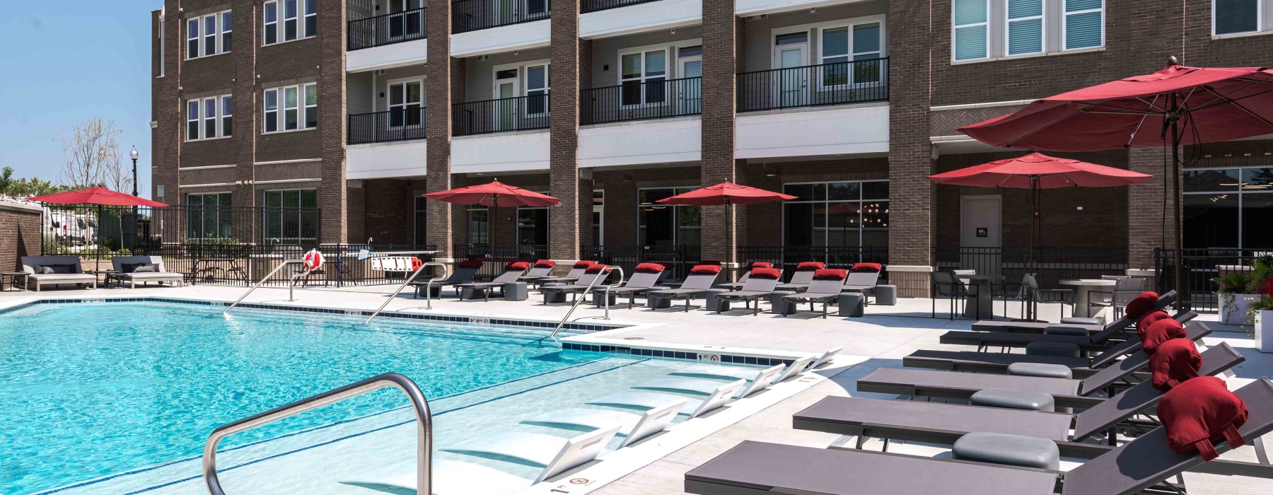 Resort-style swimming pool with lounge seating