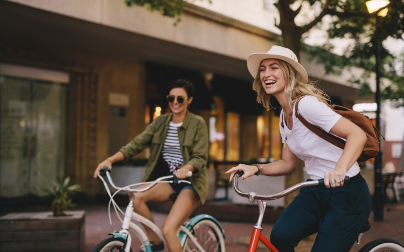Two women riding bikes